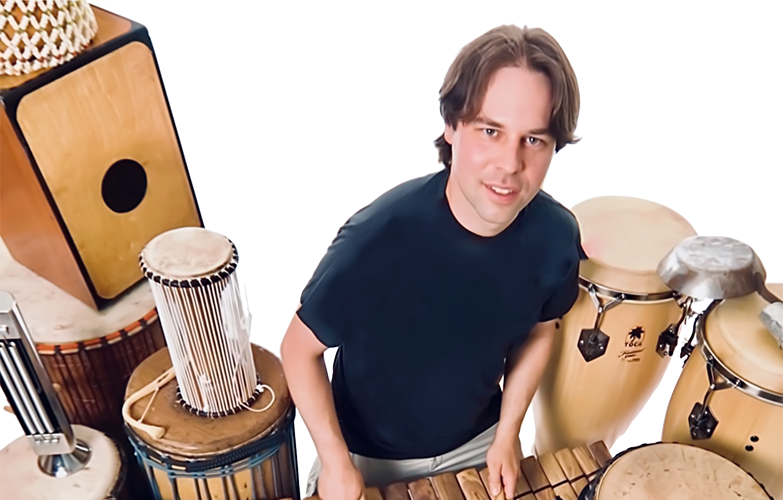 Jordan Hanson playing a xylophone surrounded by various types of drums